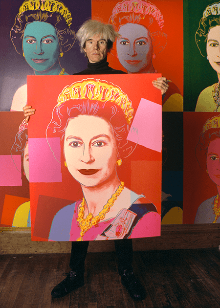 Derek Hudson, Andy Warhol holding a screenprint of Queen Elizabeth II in his studio, The Factory New York, 1985. Image: © Derek Hudson/Getty Images © 2021 The Andy Warhol Foundation for the Visual Arts, Inc. / Licensed by DACS, London